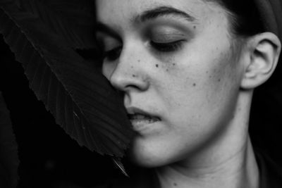 Close-up portrait of young woman looking away