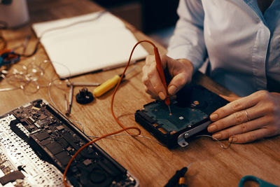 Midsection of man working on table