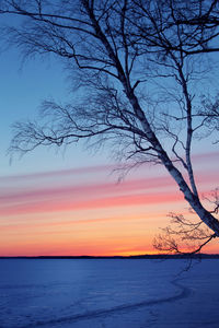 Scenic view of calm lake at sunset