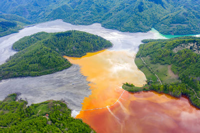 Aerial view of mining water discharged from a copper pit flooding the village of geamana, romania