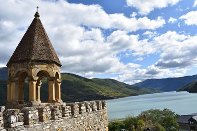 View of temple building against cloudy sky