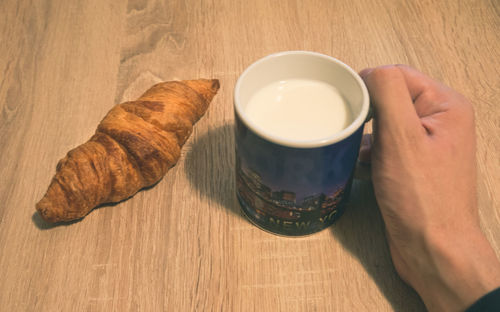 High angle view of hand feeding on table