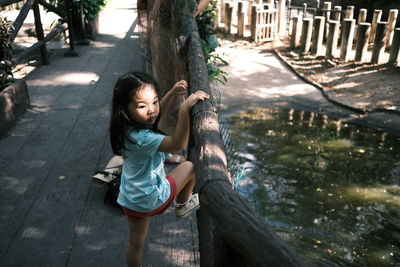 Full length of cute girl on tree