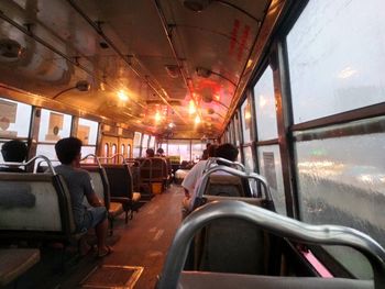 Rear view of people sitting in bus