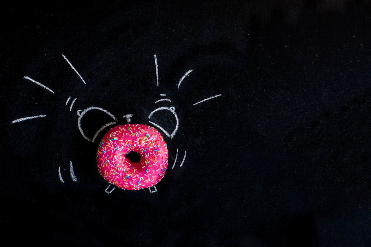 CLOSE-UP OF HEART SHAPE MADE FROM BLACK BACKGROUND AT NIGHT