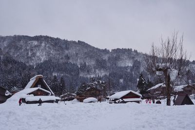 Scenic view of snow covered field against sky