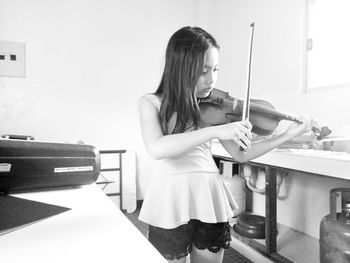 Girl playing violin at home