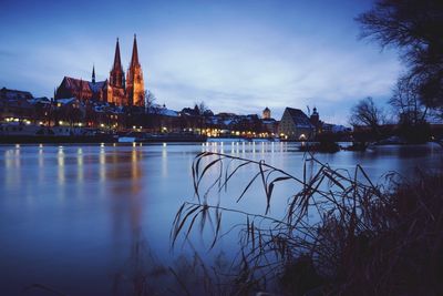 Regensburg cathedral by river against sky