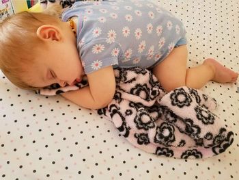 High angle view of baby sleeping on bed