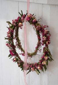 Close-up of pink flowering plant against wall