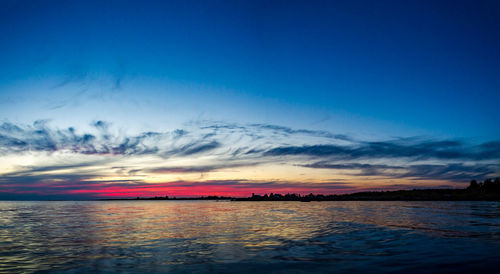 Scenic view of sea against romantic sky at sunset