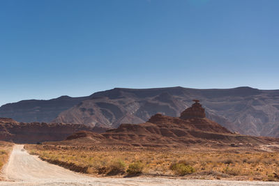 View of desert against clear blue sky