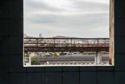 View of bridge in city against sky