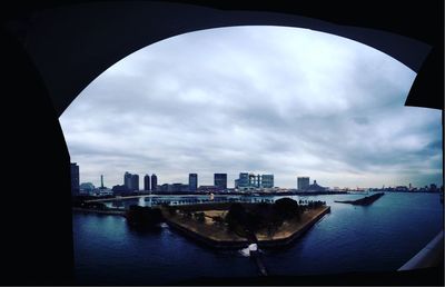 Cityscape against cloudy sky