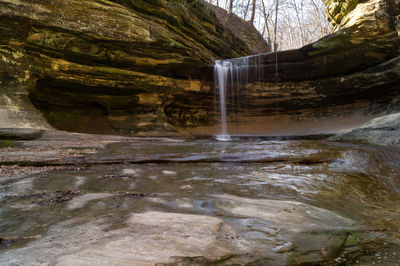 Scenic view of waterfall against sky