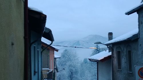 Houses against mountain during winter