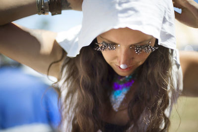 High angle view of woman with face paint and false eyelash at traditional event