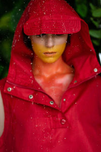 Portrait of young woman wearing red hood
