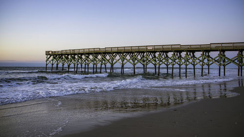 Pier over sea against clear sky