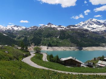 Scenic view of lake by mountains against sky