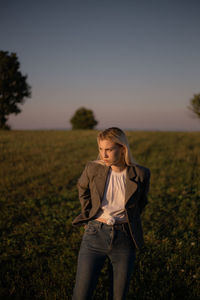 Full length of young woman standing on field