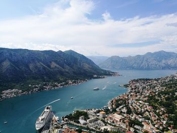 Aerial view of sea and mountains against sky