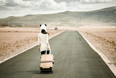 Rear view of man standing on desert