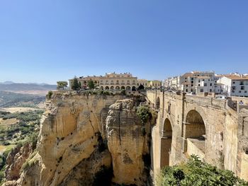 Panoramic view of castle against clear blue sky