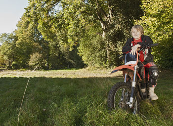 12 year old boy having a break on his off road motorbike