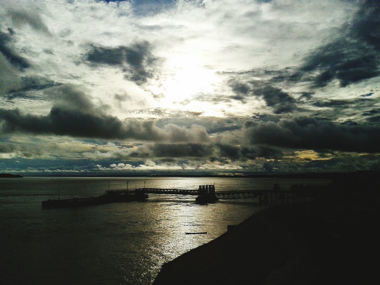 water, sky, sea, cloud - sky, scenics, tranquil scene, tranquility, cloudy, beauty in nature, horizon over water, nature, cloud, idyllic, weather, sunset, pier, calm, overcast, beach, dusk