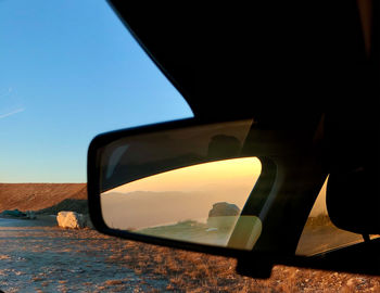 Reflection of sky seen through car windshield