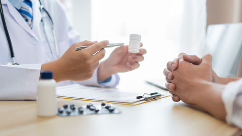 Midsection of doctor examining patient at clinic