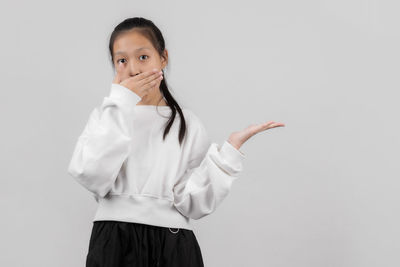 Portrait of a teenage girl against white background