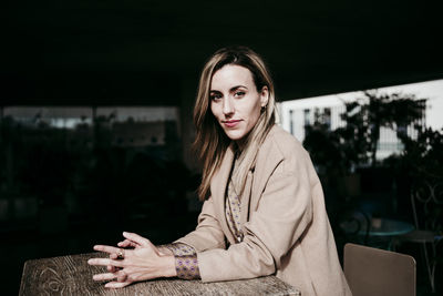 Portrait of woman sitting outdoors