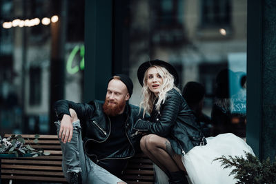 Young couple sitting outdoors