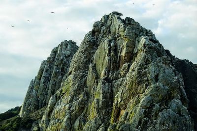 Low angle view of rock formation against sky