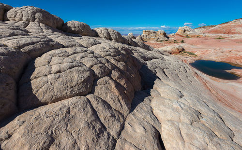 Rock formation on land against clear blue sky