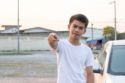 Portrait of young man standing outdoors