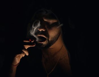 Man smoking cigarette in dark