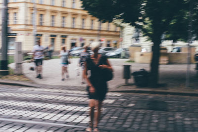 Blurred motion of person walking in city