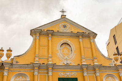 Low angle view of ornate building against sky