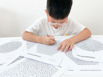 High angle view of man reading book on table