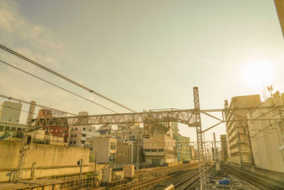 Cranes at construction site against sky in city