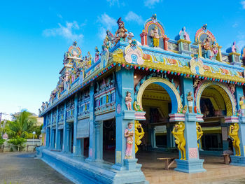 Statue of temple against blue sky