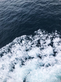 High angle view of waves splashing on sea