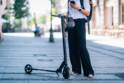 Low section of man standing on footpath