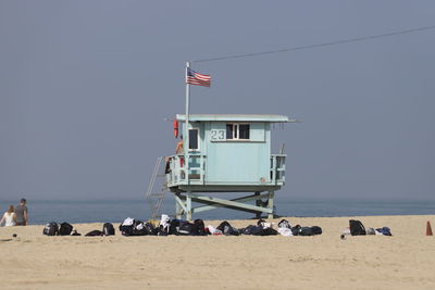 People on beach against clear sky