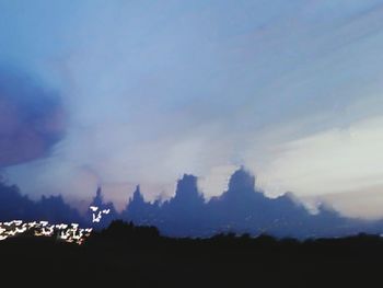 Silhouette landscape against blue sky