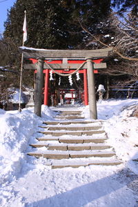 Gazebo in park by building during winter