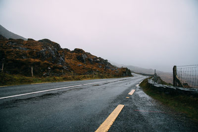 Misty lonely road in the wild atlantic way of ireland